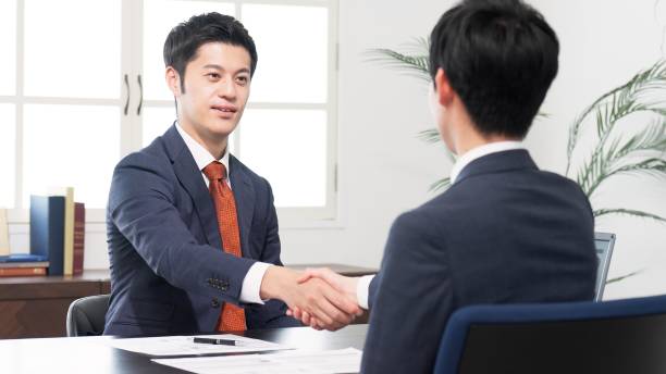 istock Businessmen shaking hands at a meeting 2180675816