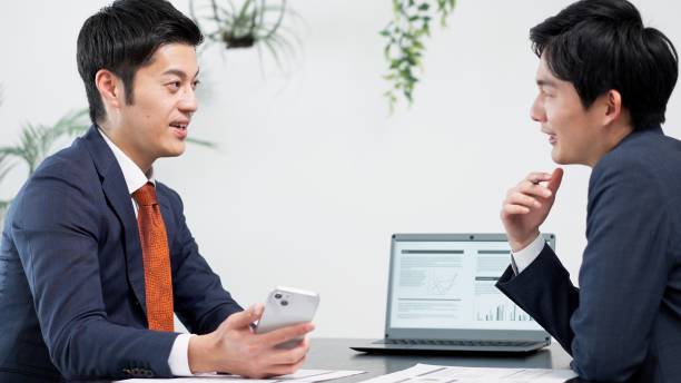 istock Businessman using smartphone at a meeting 2180675817