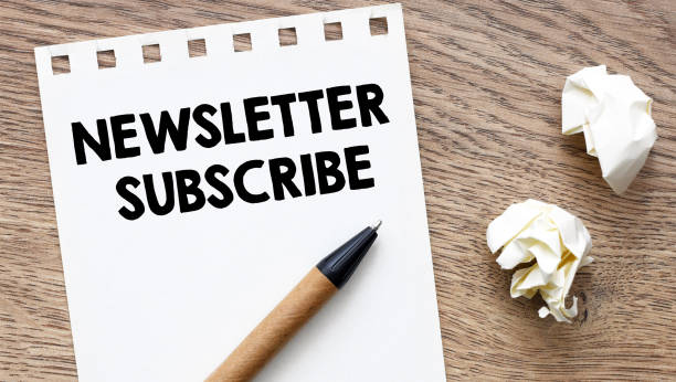 istock NEWSLETTER SUBSCRIBE - words on a white notebook.Education concept 2180677636