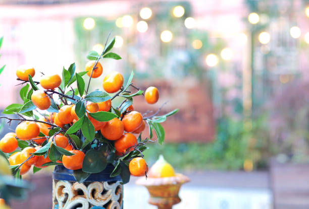 Branch with tangerines in ceramic vase on table. Traditional pattern, Sicily, Italy. Fruit and decor.