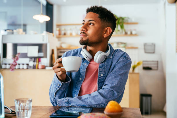 istock Handsome young hispanic man sitting in a bar cafeteria 2180679889