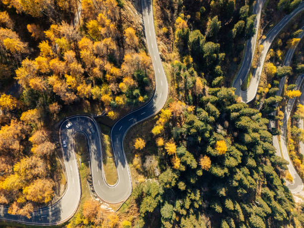 istock Winding Mountain Road Through Autumn Forest 2180682287