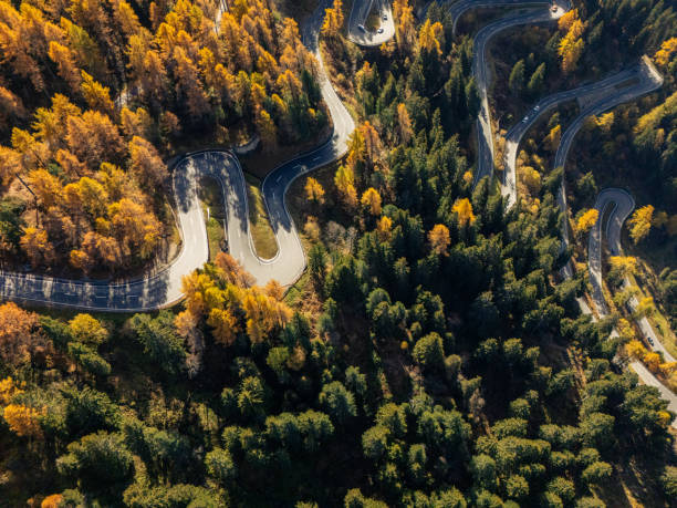 istock Winding Mountain Road Through Autumn Forest 2180682354
