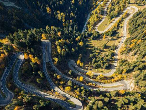 istock Winding Mountain Road Through Autumn Forest 2180682617
