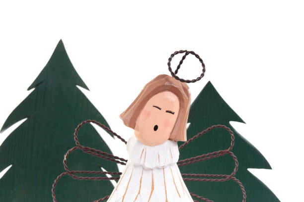 Wooden Xmas tree with cute Christmas guardian. Minimalist design. Holiday season decoration or celebration. Selective focus. White background.
