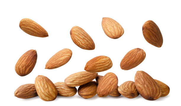 istock Almond kernels nuts falling on a pile on a white background. Isolated 2180682877