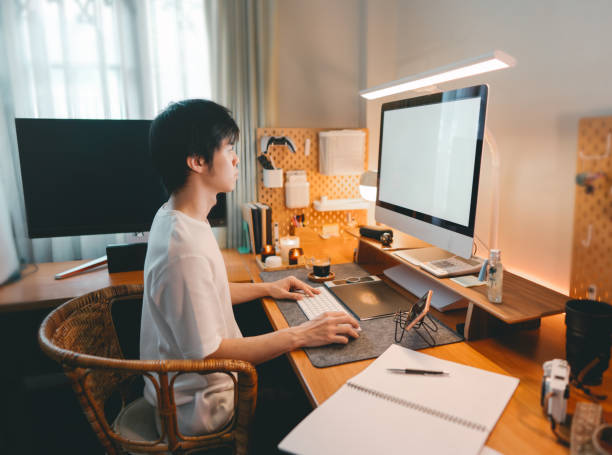 istock Freelance asian man working at home modern office cozy room warming lighting ambient 2180683278