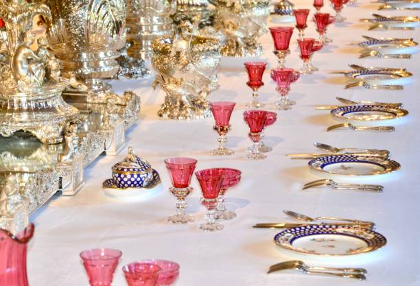 istock Luxury expensive table setting at a wedding or banquet has deluxe tableware, white tablecloths, beautiful crystal  glasses, silver tureens and serving ware and looks ready for diners 2180685025