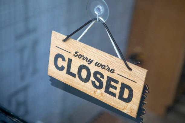 istock Closed sign in a shop door window 2180687181