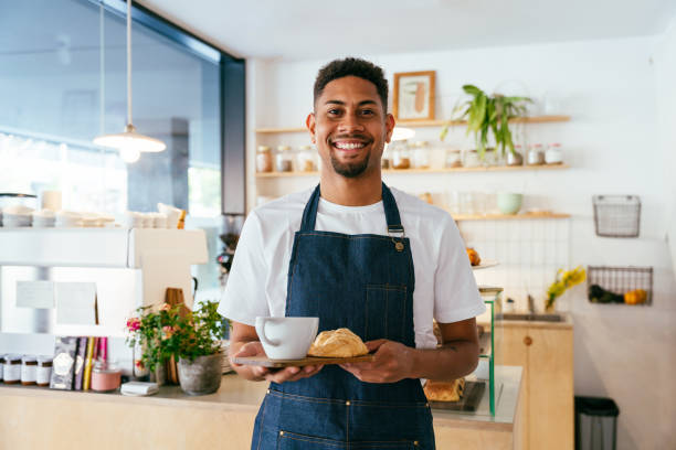 istock Barista working in a bar cafeteria 2180687230