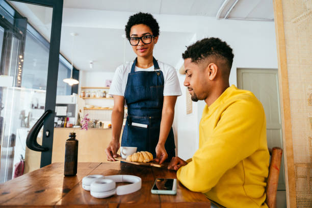 istock Barista working in a bar cafeteria 2180687320