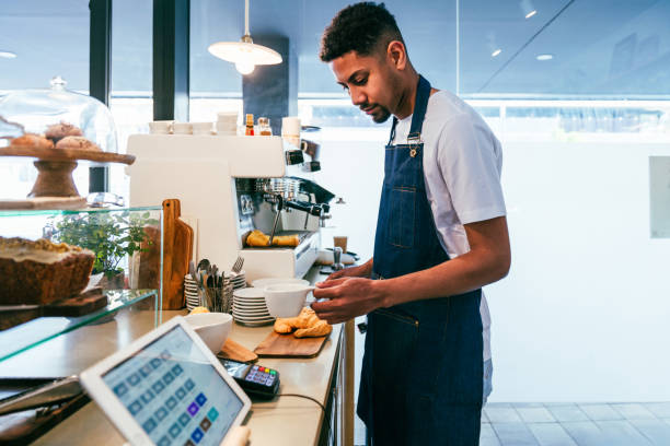 istock Barista working in a bar cafeteria 2180687480