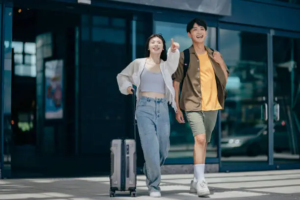 After walking out of the station, a traveler uses their smartphone to check information, ensuring they're on the right path to their destination. After walking out of the station, a traveler uses their smartphone to check information, ensuring they're on the right path to their destination.