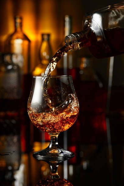 istock Pouring brandy from a bottle into a glass. 2180689297