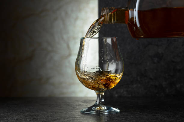 istock Pouring brandy from a bottle into a glass. 2180689311