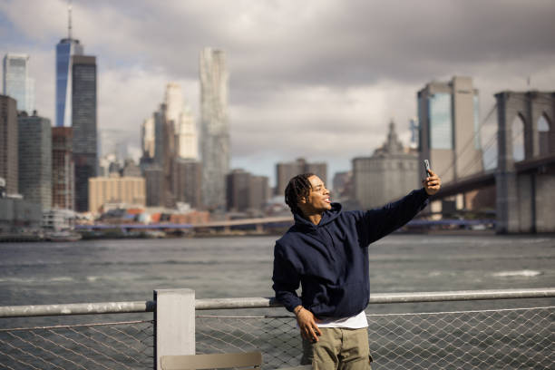 istock Happy African American man taking a selfie by the river. 2180689847