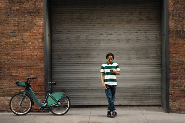 istock Happy African American man using smart phone on the street. 2180690850