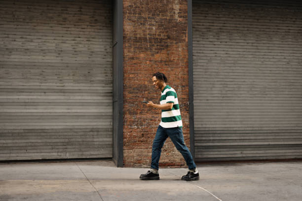 istock Happy African American man using smart phone on the move. 2180690895