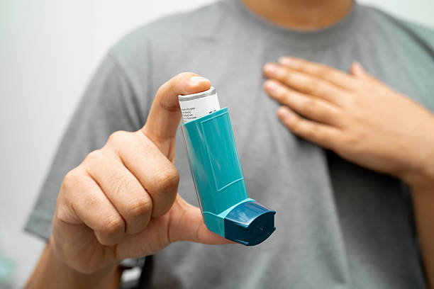 istock Asthma and chronic obstructive pulmonary disease COPD, Asian young man using metered dose inhaler MDI. 2180692428