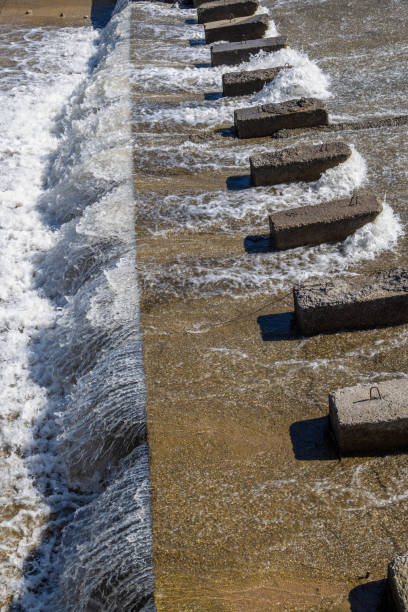 istock chute dentate blocks in concrete water spillway channel 2180692893
