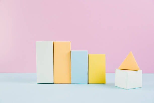 istock Geometric shapes in different colors on pink background. Dimensional solid figures on colored paper 2180693091