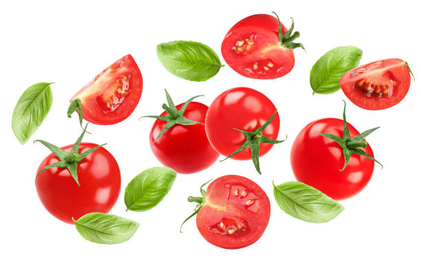 istock flying fresh tomatoes with green leaves isolated on white background. clipping path 2180694887