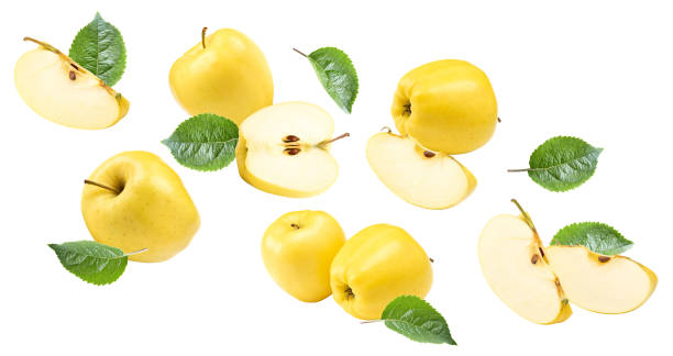 istock flying yellow apples with green leaf and slices isolated on a white background. clipping path 2180694921