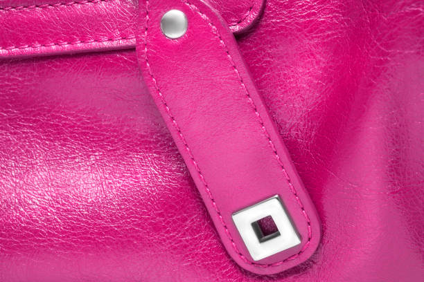 Fuchsia pink leather bag details closeup as a background