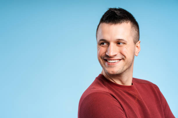 istock Confident, smiling middle aged man looking away on copy space isolated on blue background 2180702770