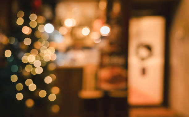 Abstract colorful Christmas bokeh lights festive background with blurred shop or restaurant at night