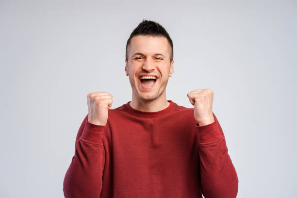 istock Overjoyed, successful man, winner holding hands up, win money looking at camera 2180703270