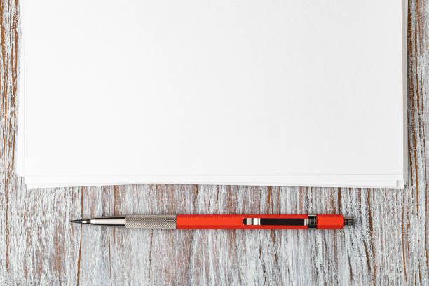 Blank paper with mechanical pencil on wood table