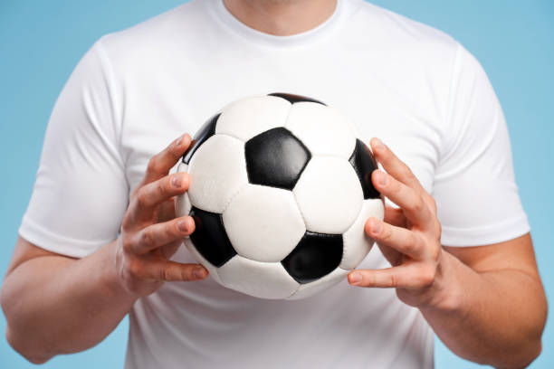 istock Soccer player holding classic black and white ball 2180704020