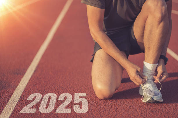 istock Athletes are getting ready to run on the track with text Start 2025 in New Year's start concept 2180704171