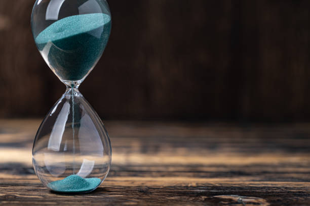 istock hourglass with green sand 2180706731