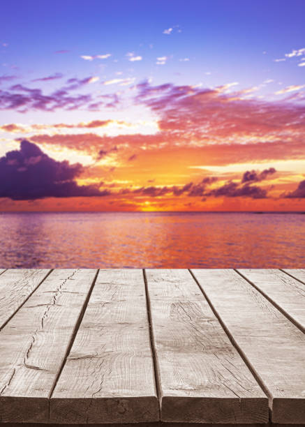 istock Empty wooden table top with tropical ocean sunrise background 2180707654