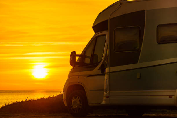 istock Camper vehicle on beach at sunrise 2180709939