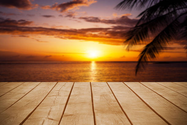 istock Empty wooden table top with tropical ocean sunrise background 2180710780