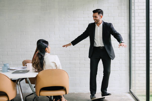 istock Asian Indian business people doing balance exercise while meeting in office. 2180711101