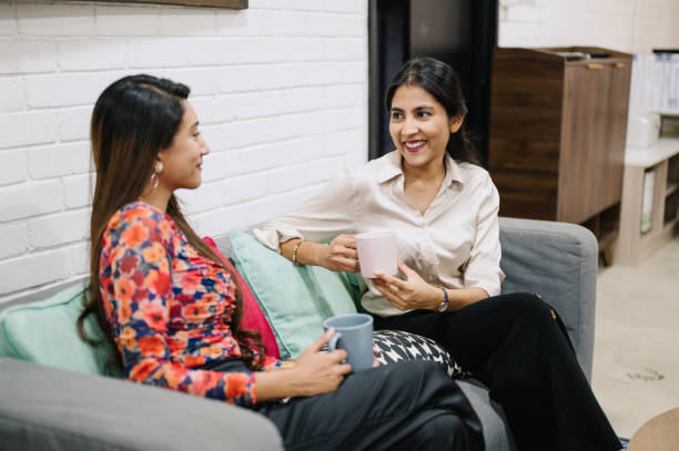 istock Two Asian Indian businesswomen relax and talking in office while break time. 2180711231