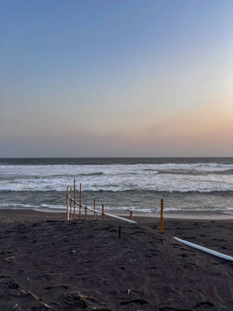 istock The beach is empty and the sky is blue. The ocean is calm and the sun is setting 2180714659