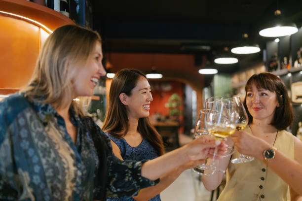 istock Female friends tasting wine in a winery 2180715325