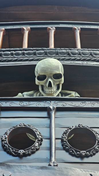 Halloween skeleton leaning over a pirate ship ideal for halloween