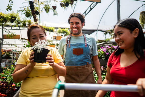 istock Salesman helping customers at a garden center 2180716098