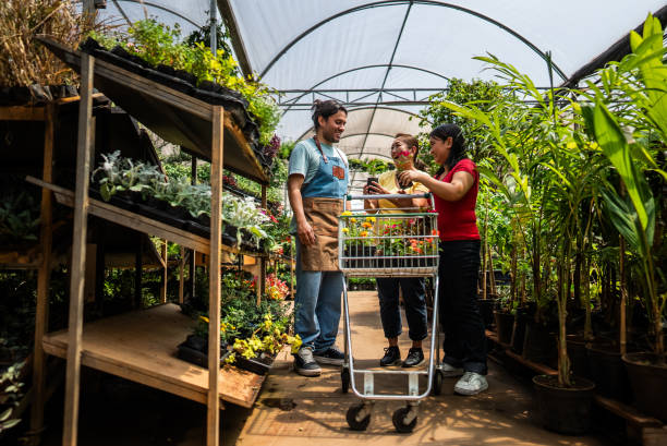 istock Salesman helping customers at a garden center 2180716129