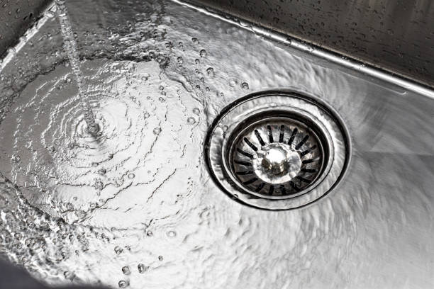 istock water drains down a stainless steel sink 2180717546