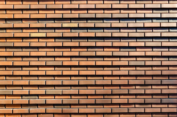 background, texture of red brown brick wall. Facing bricks on the facade of a modern building.
