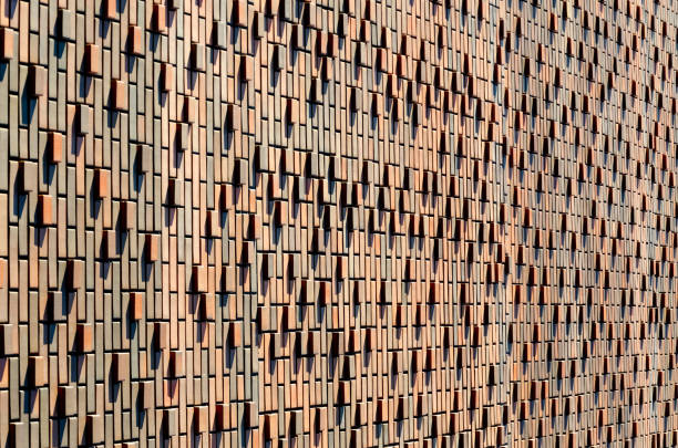 background, texture of red brown brick wall. Facing bricks on the facade of a modern building.