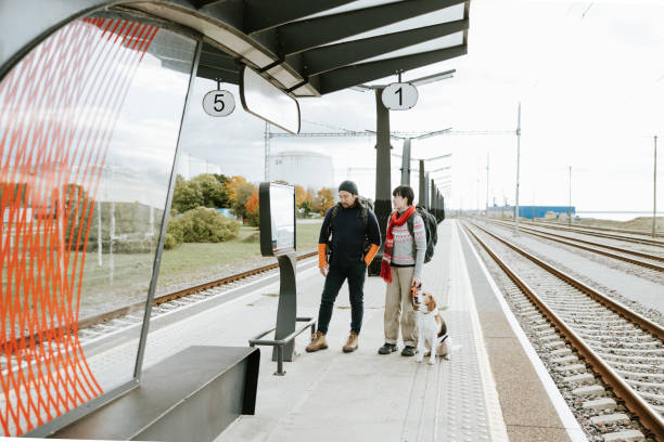 istock Standing at the platform, the hikers analyze the timetable, calculating the best connection to reach their next stop. 2180717774