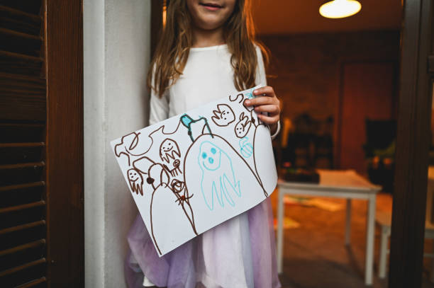 istock Cute girl drawing for halloween. 2180720657